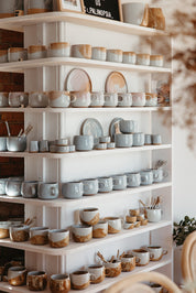 Stacked shelves with handmade Palinopsia coffee mugs and cups 