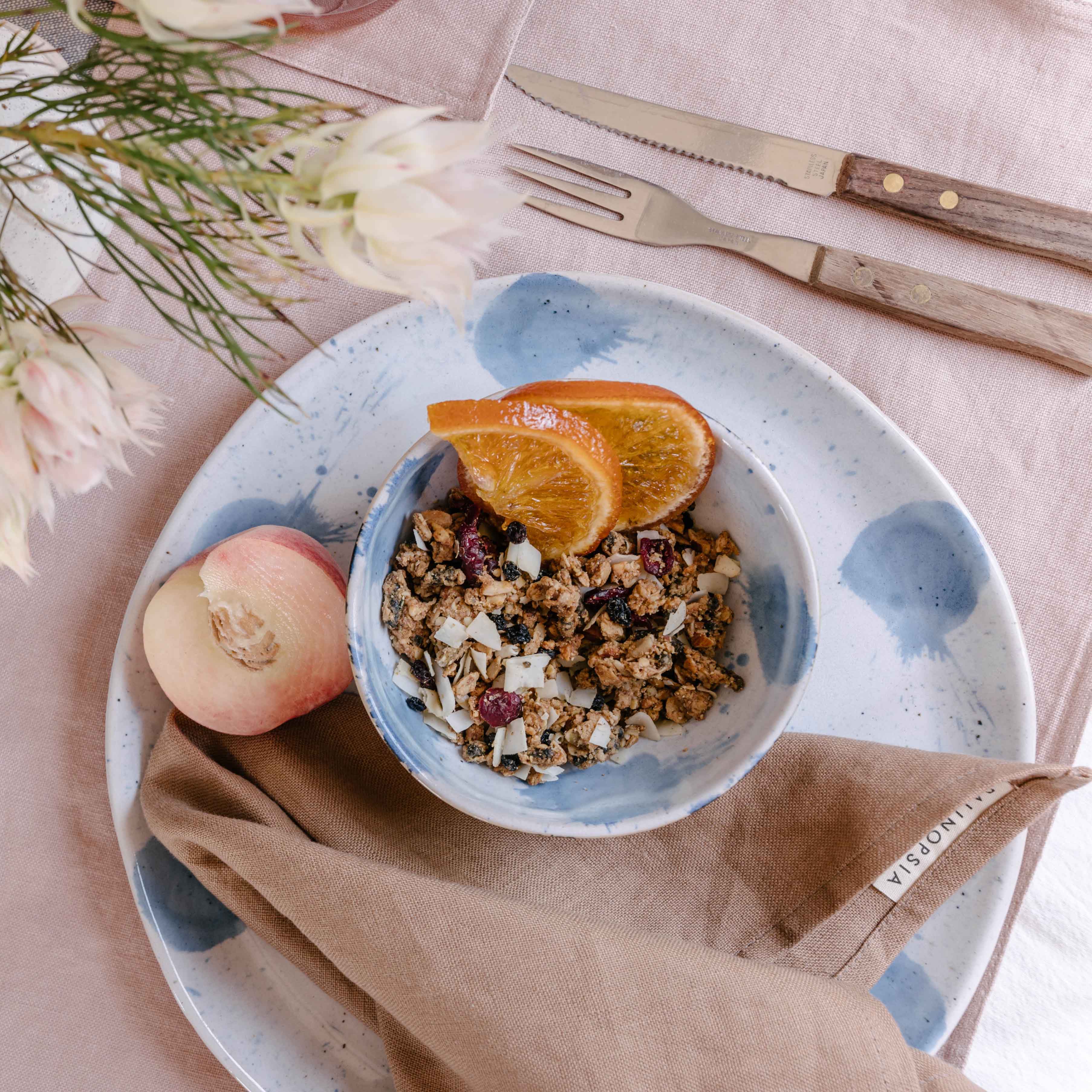 Palinopsia Ceramics Pollock breakfast bowl and dinner plate on a dining table with linen napkin and tablecloth